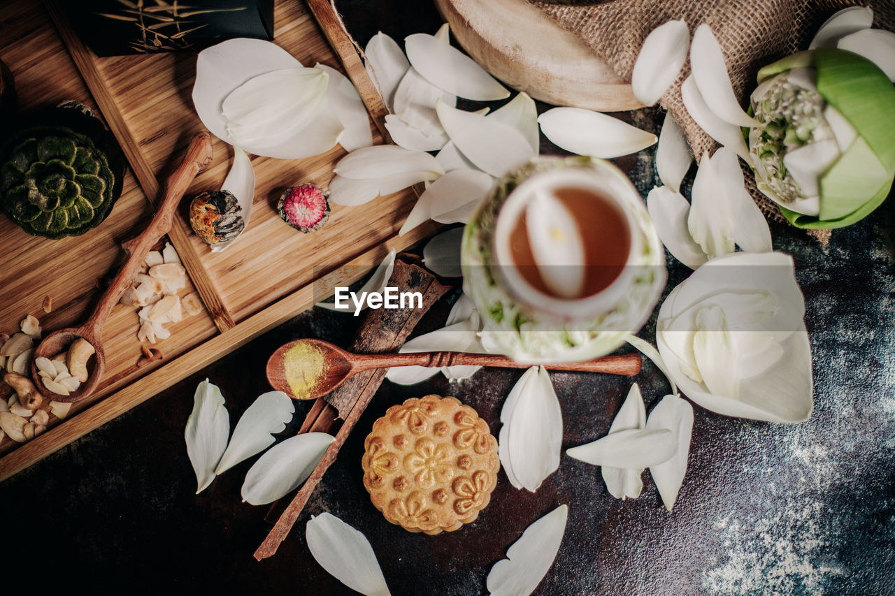 High angle view of coffee and petals on table