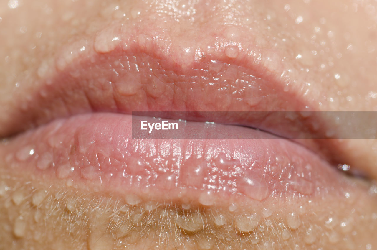 Cropped image of wet woman lips