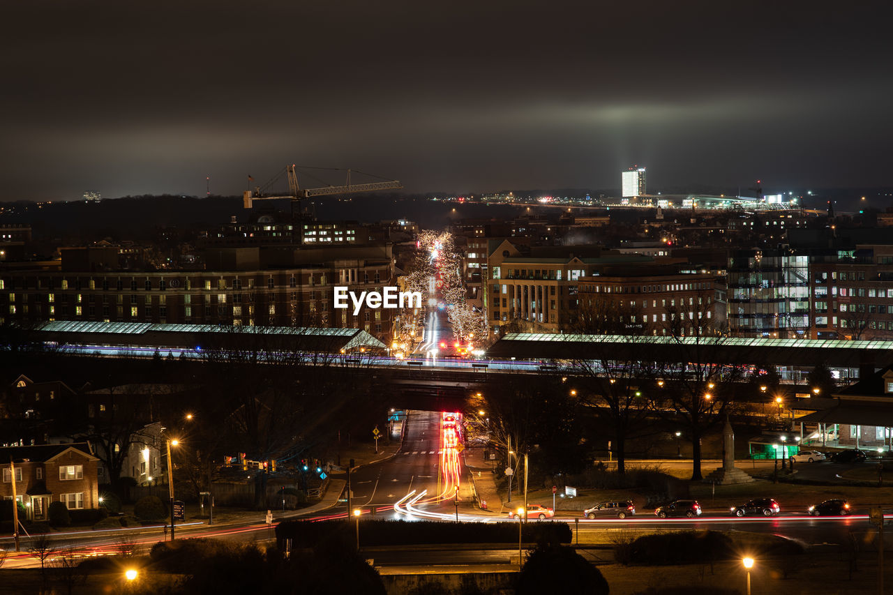 HIGH ANGLE VIEW OF ILLUMINATED BUILDINGS AT NIGHT