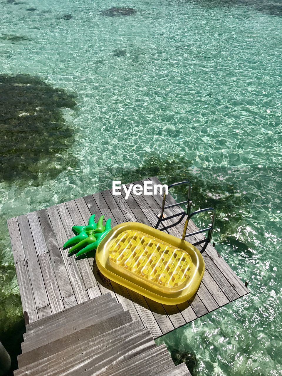 High angle view of yellow pier by sea