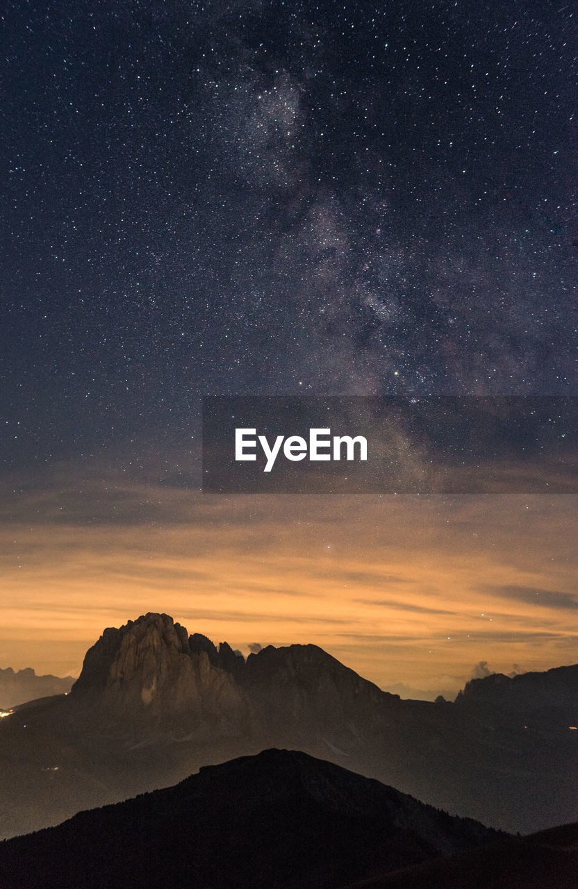 Scenic view of mountains against sky at night