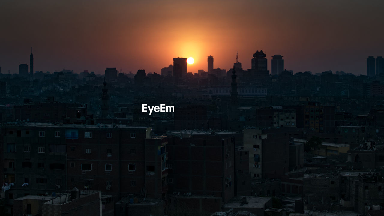 Cityscape against sky during sunset