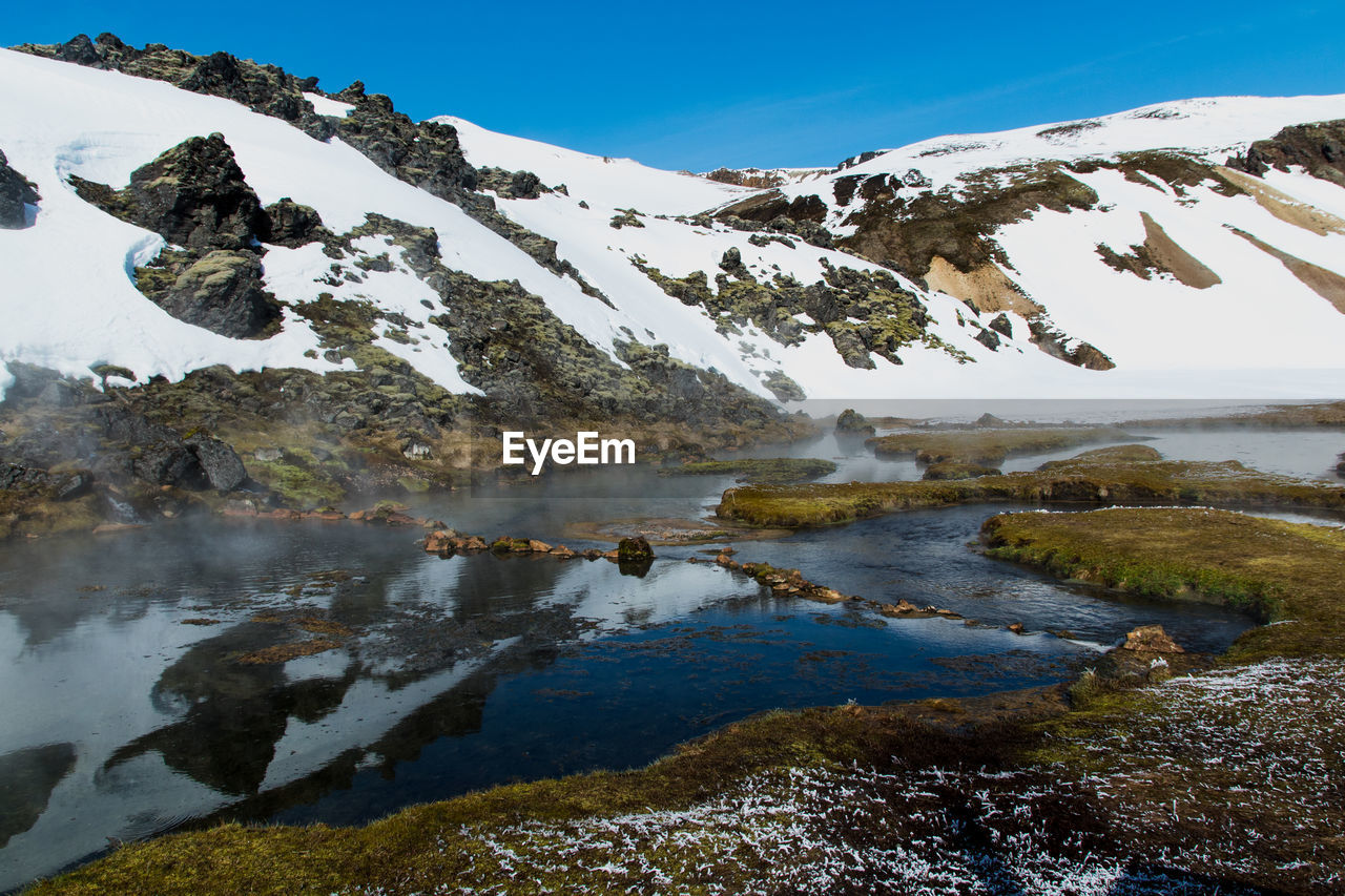 Scenic view of lake against sky during winter