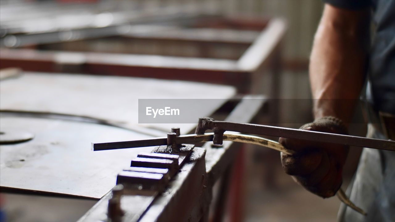 Midsection of man playing piano