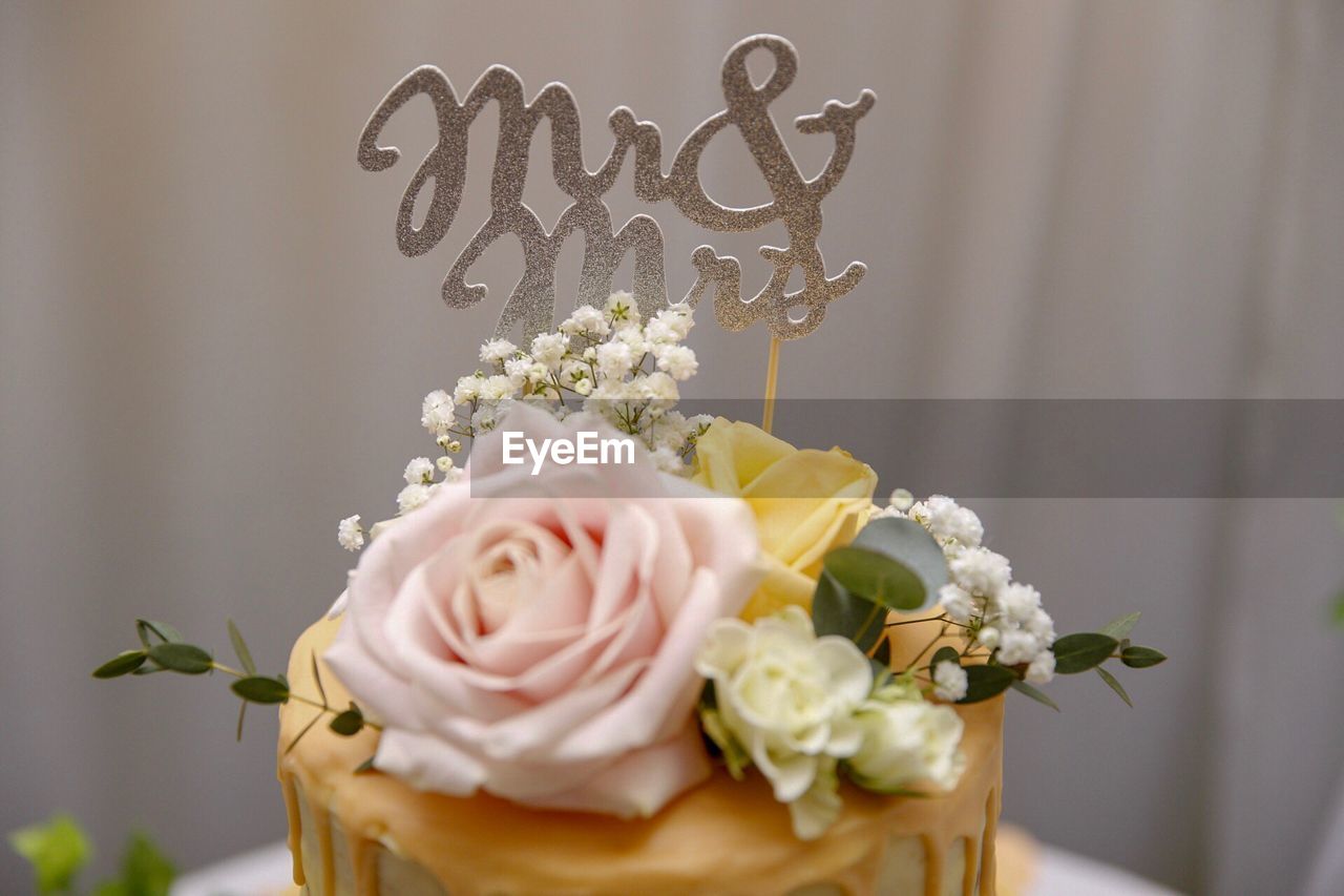 Close-up of prop with text on cake