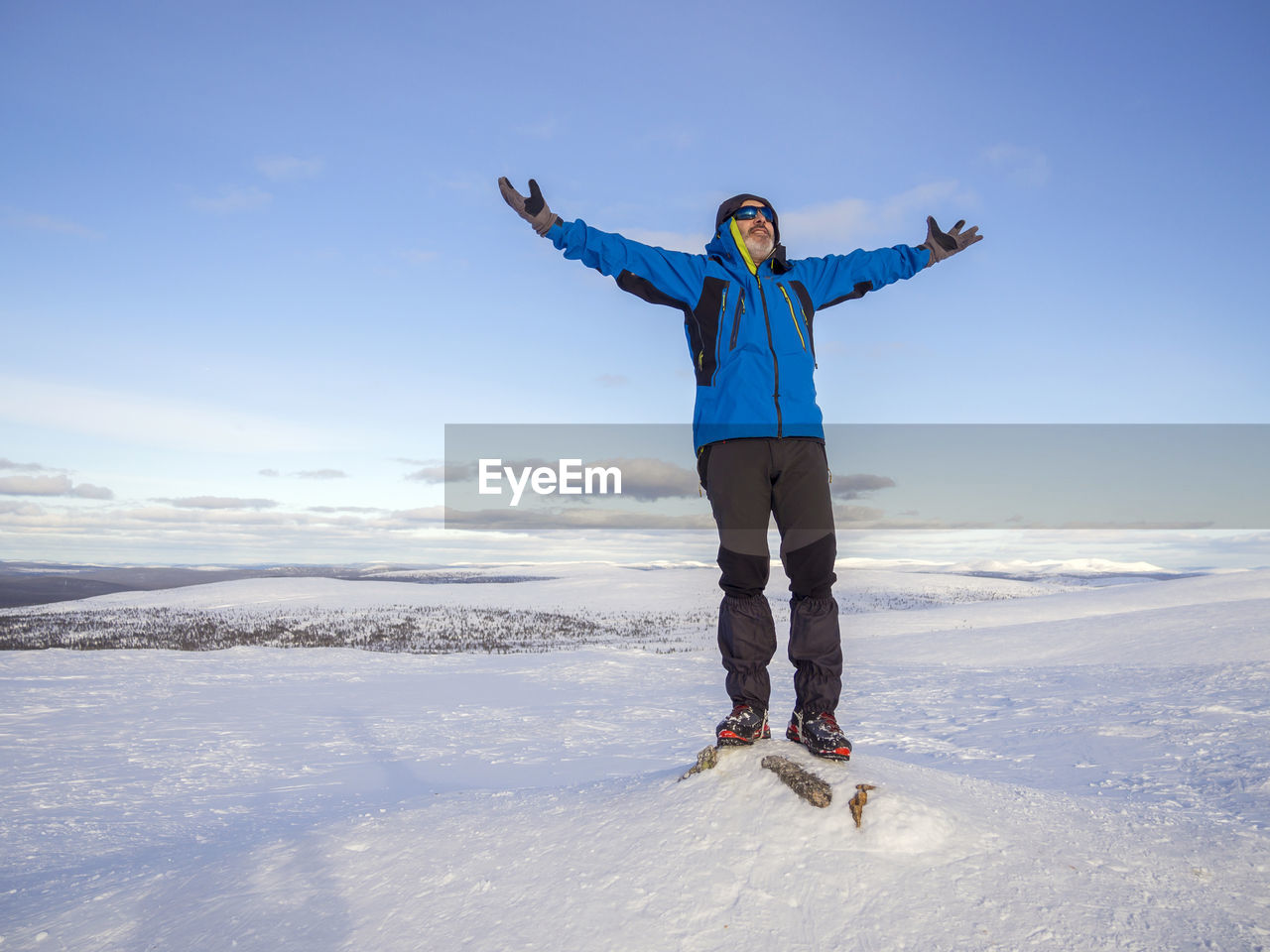 Full length of man standing on snow covered landscape