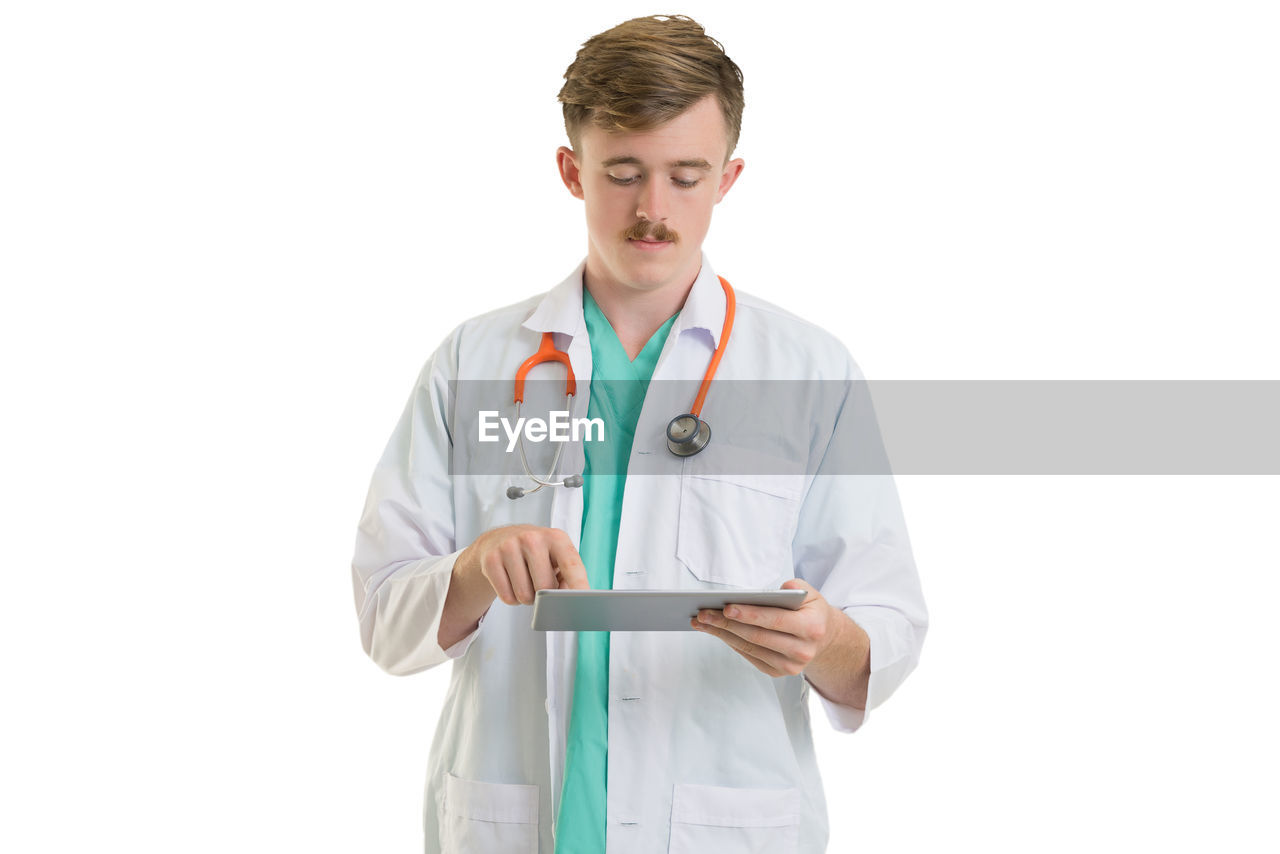 Doctor standing against white background