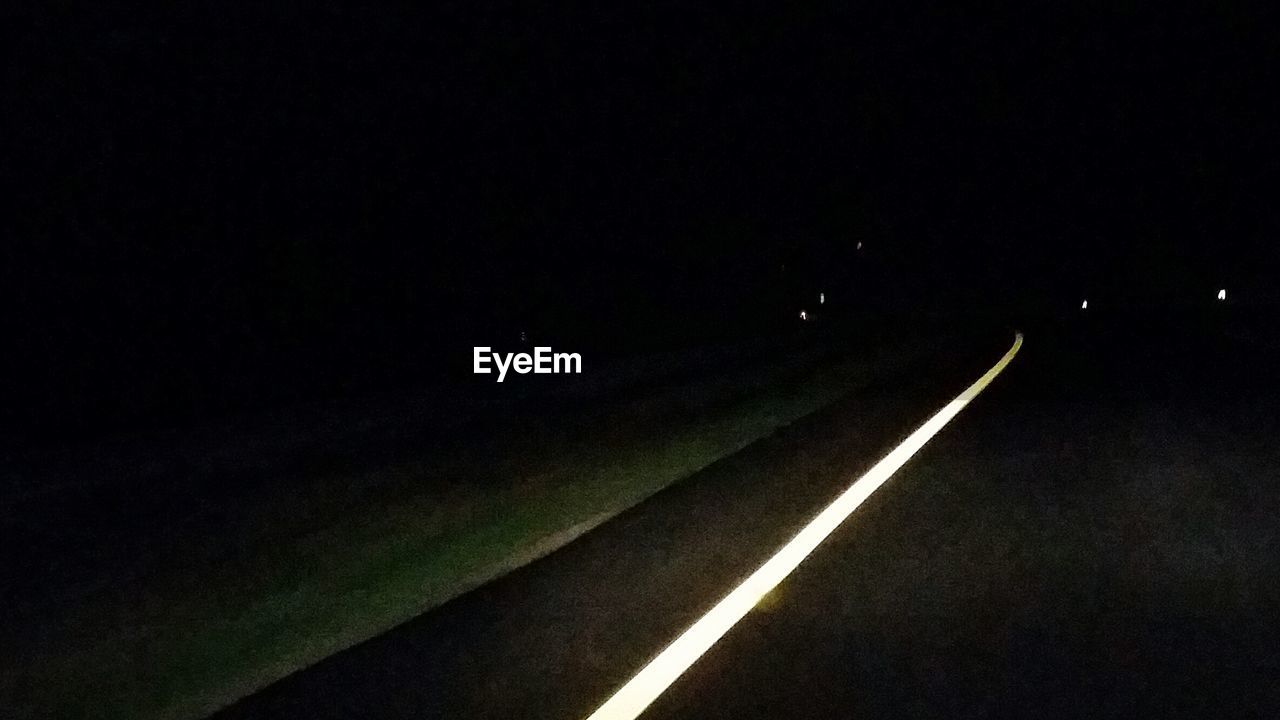 ROAD PASSING THROUGH ILLUMINATED TUNNEL