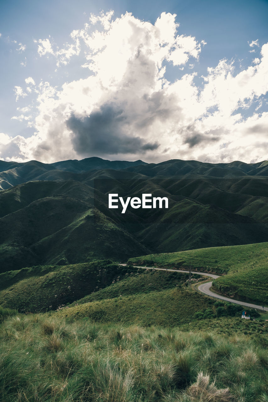 SCENIC VIEW OF FIELD AND MOUNTAINS AGAINST SKY