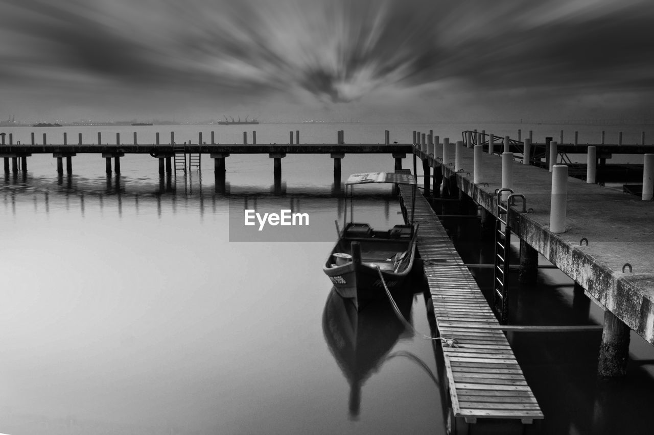 Wooden pier over sea against sky