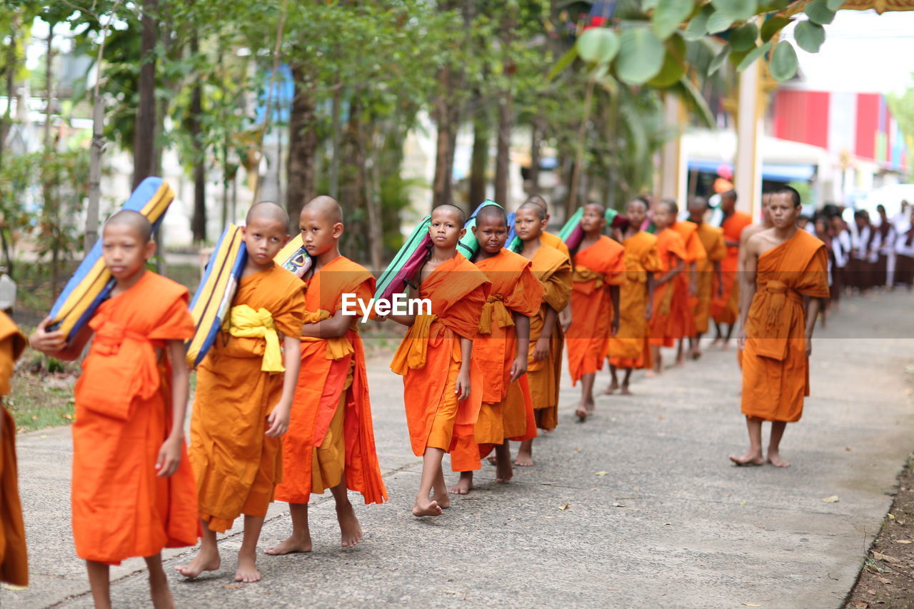 GROUP OF PEOPLE WALKING IN ROW