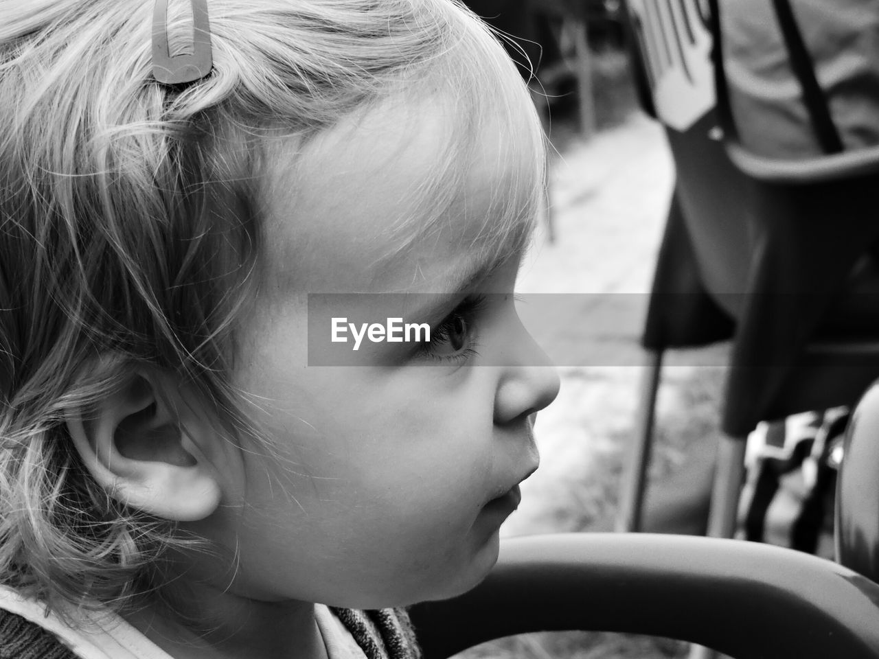 CLOSE-UP OF LITTLE GIRL LOOKING AWAY