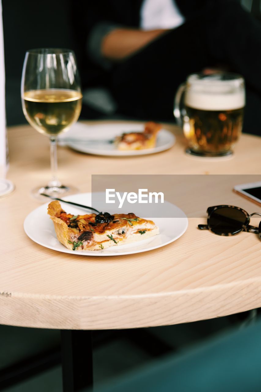 Close-up of food with wineglass on table in restaurant