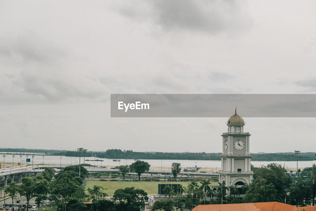 Panoramic view of building and trees against sky