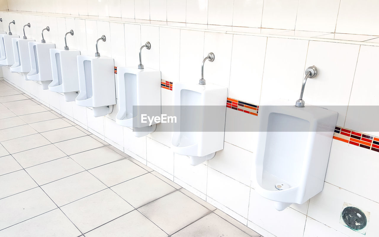 View of urinal in public restroom