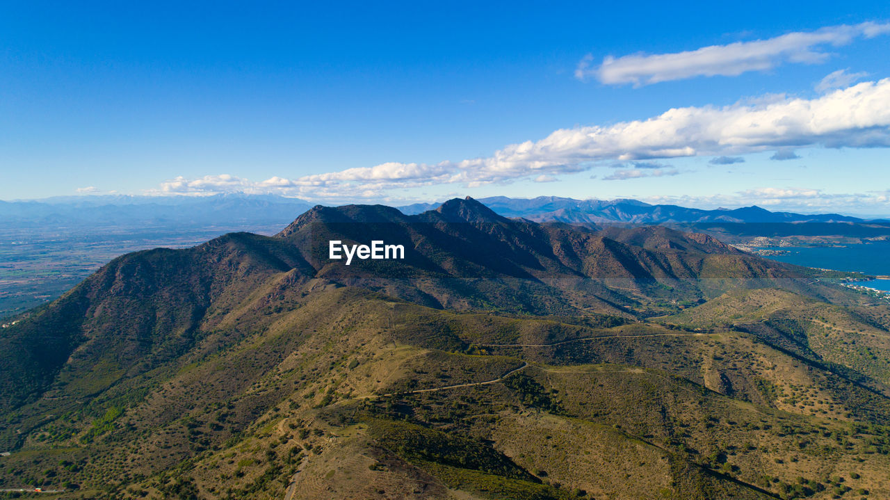 VIEW OF MOUNTAIN RANGE AGAINST CLOUDY SKY