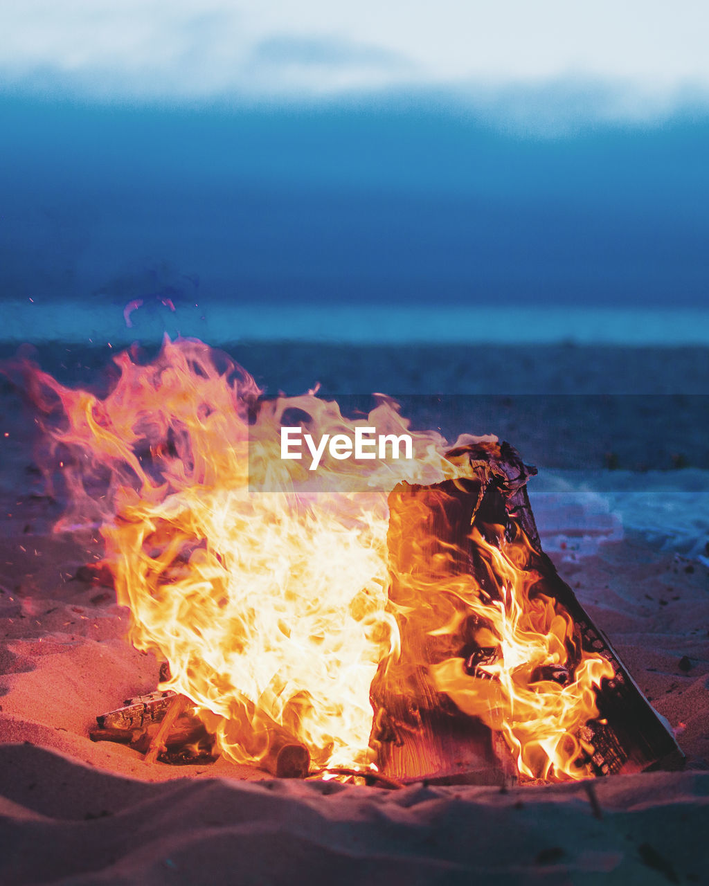 Campfire at beach during sunset