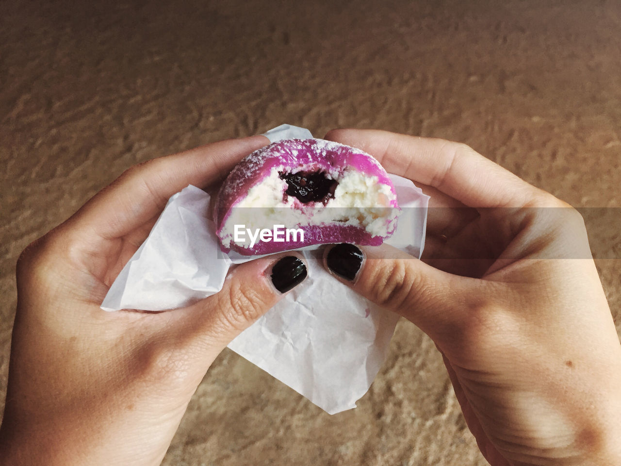 Midsection of person holding mochi ice cream