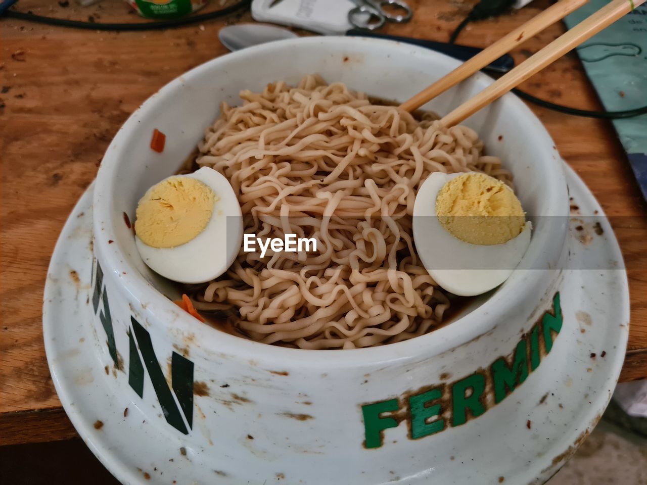 food and drink, food, dish, pasta, noodle, italian food, healthy eating, freshness, plate, meal, cuisine, wellbeing, table, asian food, high angle view, no people, indoors, bowl, wood, kitchen utensil, egg, eating utensil, crockery, still life, serving size, chopsticks, close-up