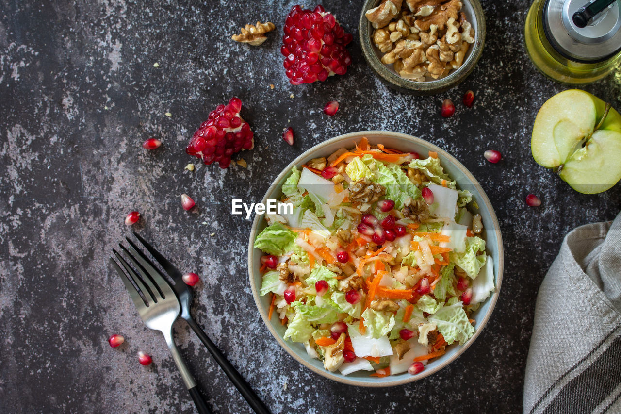 Autumn dietary chinese cabbage salad fresh vegetable, carrots, apple, nuts. 