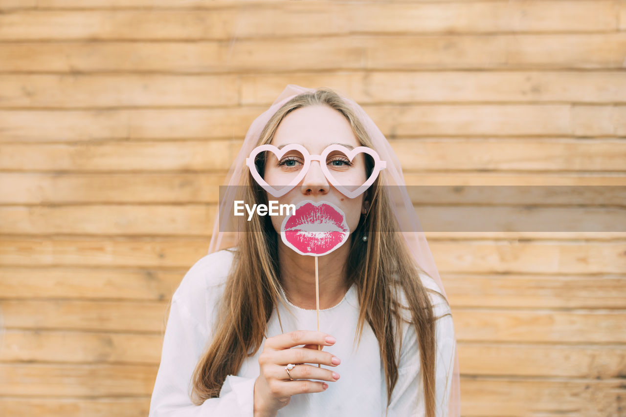 Portrait of woman holding sunglasses