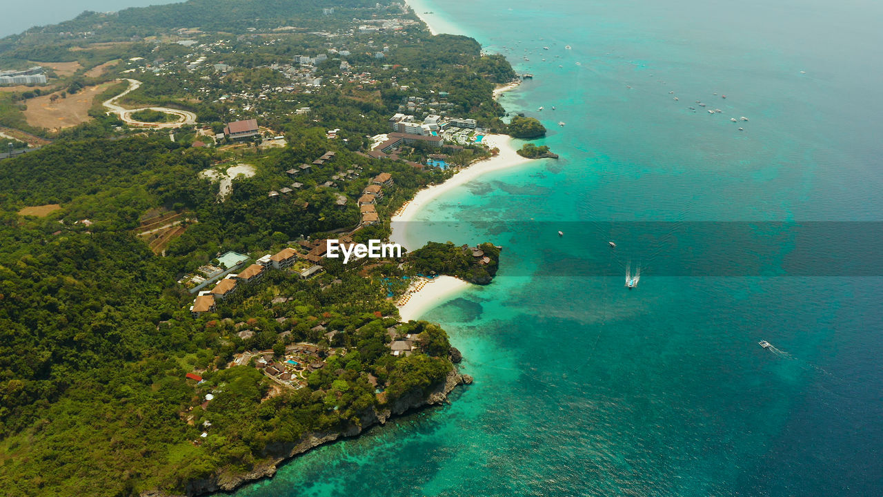 Shore of the tropical island of boracay with sandy beaches and hotels from above. 
