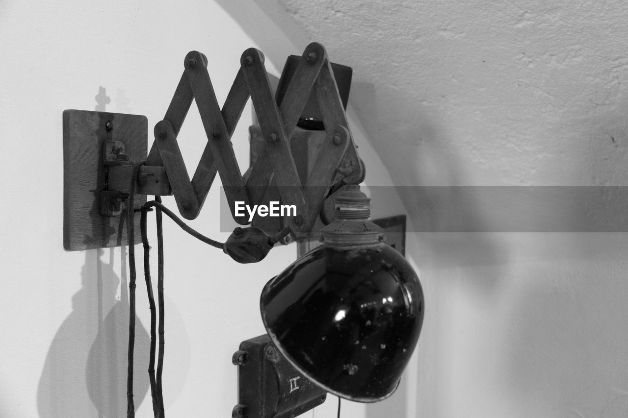 Close-up of electric lamp on wall