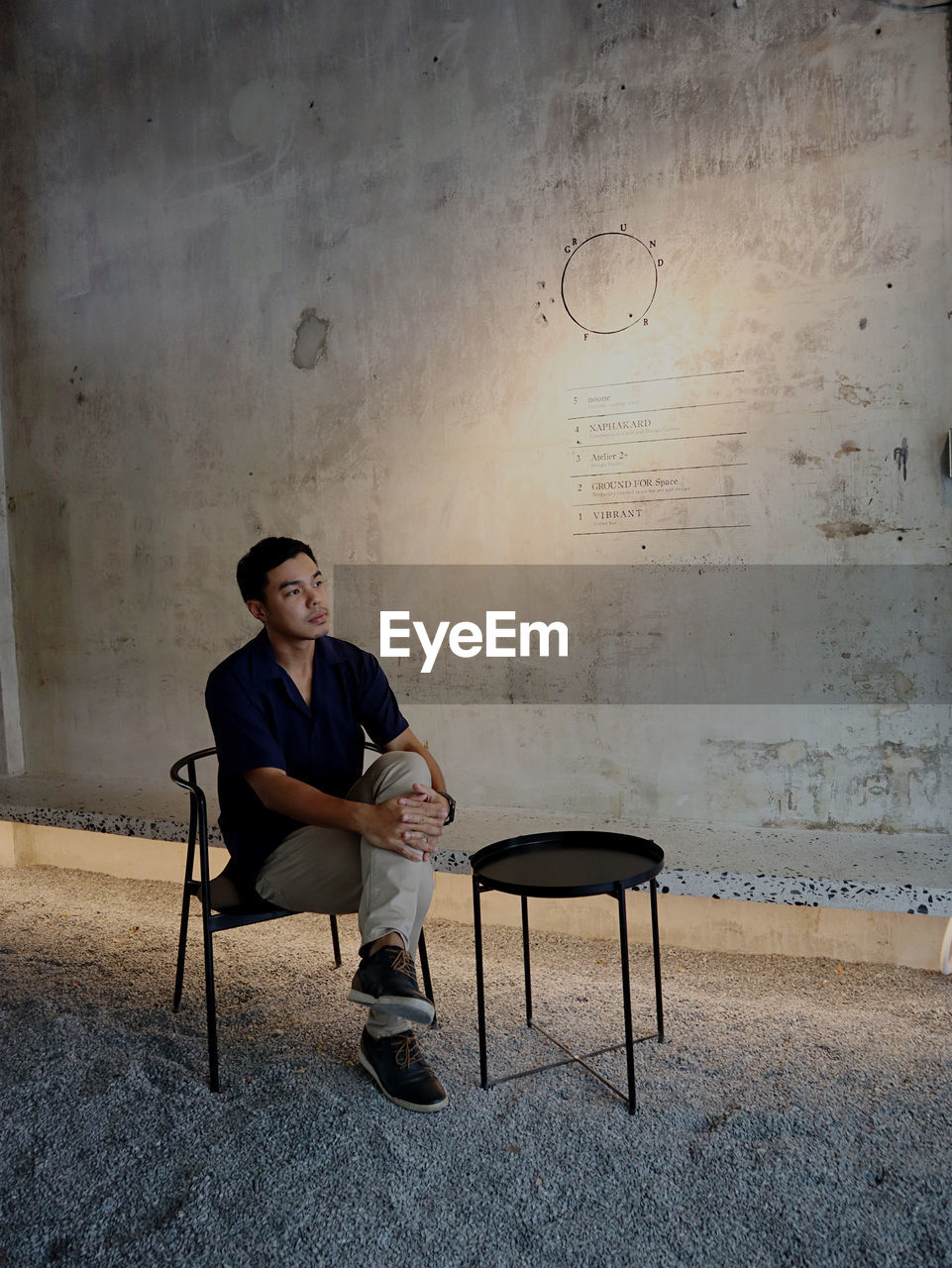 Young man sitting on chair and thinking 