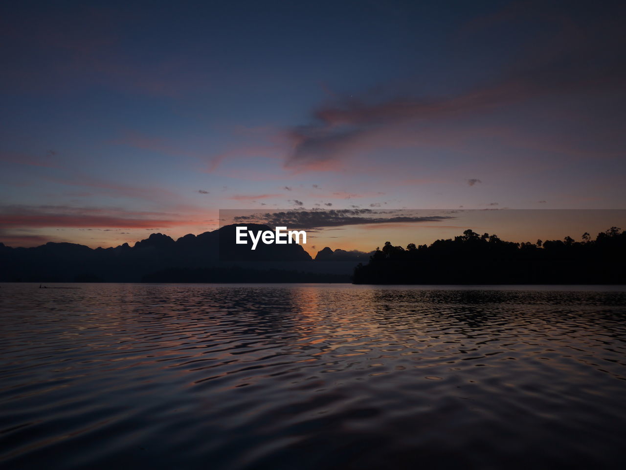 Scenic view of lake against sky during sunset