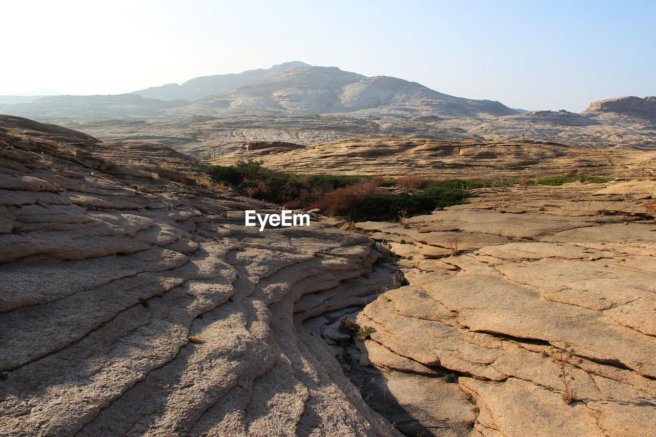 Volcanic layered mountains in the bektau-ata tract at sunset