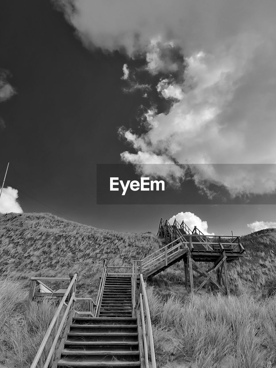 Staircase on field against sky