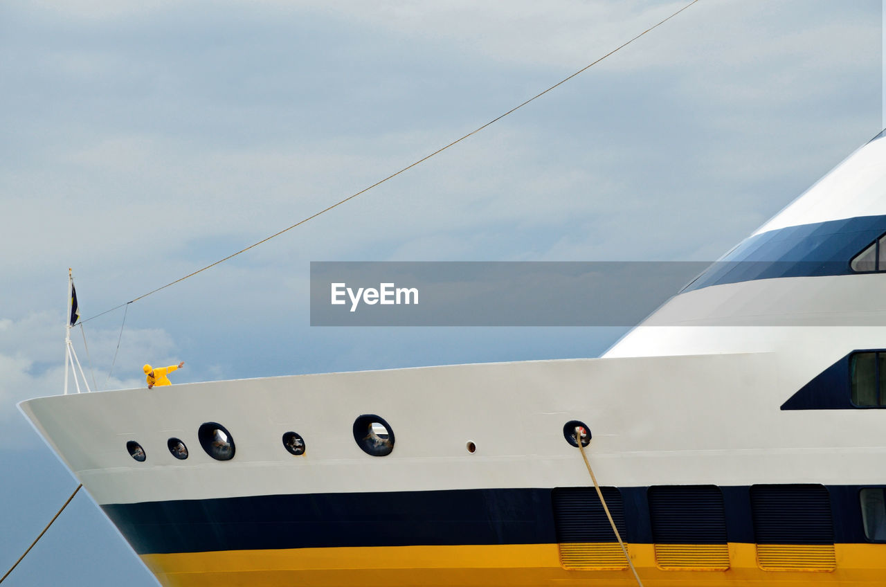 Cropped image of boat against cloudy sky