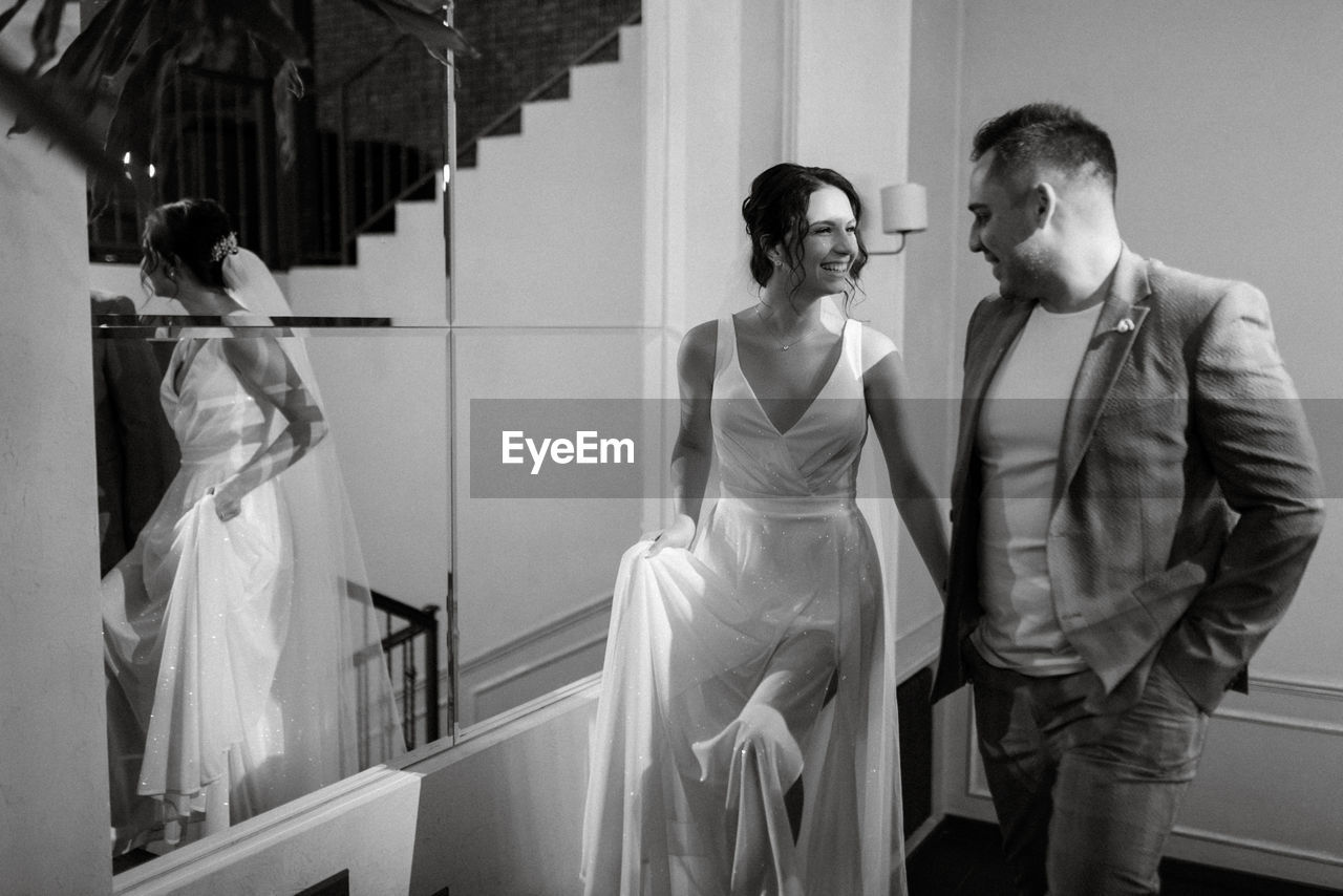 adult, bride, wedding dress, black and white, two people, men, women, wedding, white, monochrome photography, young adult, monochrome, fashion, ceremony, indoors, love, emotion, togetherness, event, three quarter length, clothing, celebration, business, newlywed, black, female, standing, positive emotion, formal wear, married, dress, lifestyles, life events, happiness
