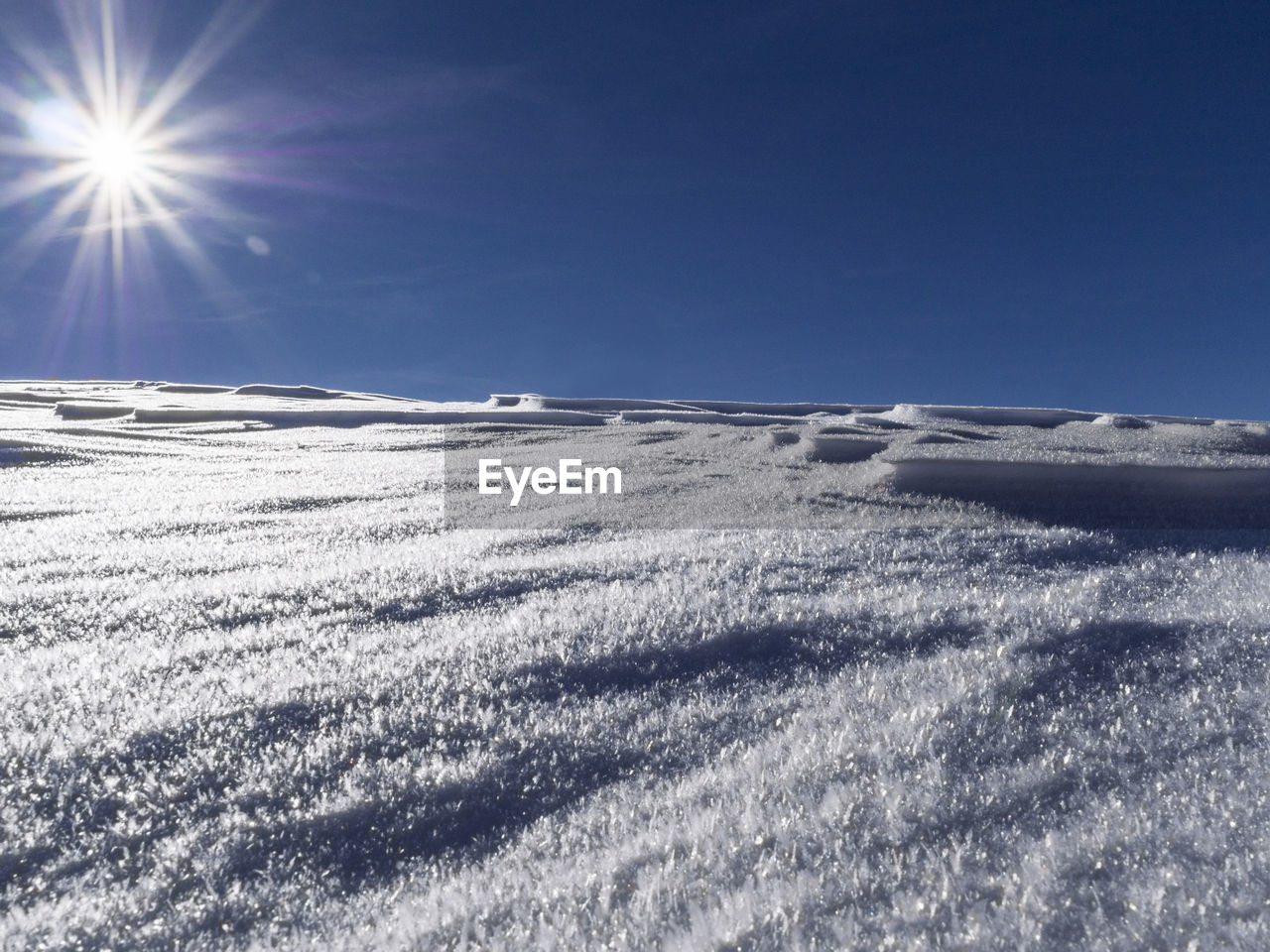 SCENIC VIEW OF SNOWY FIELD AGAINST CLEAR SKY