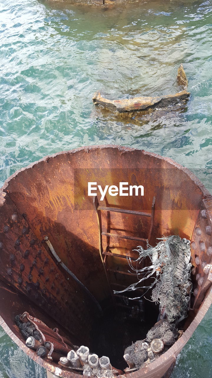 Detail shot of abandoned boat in water