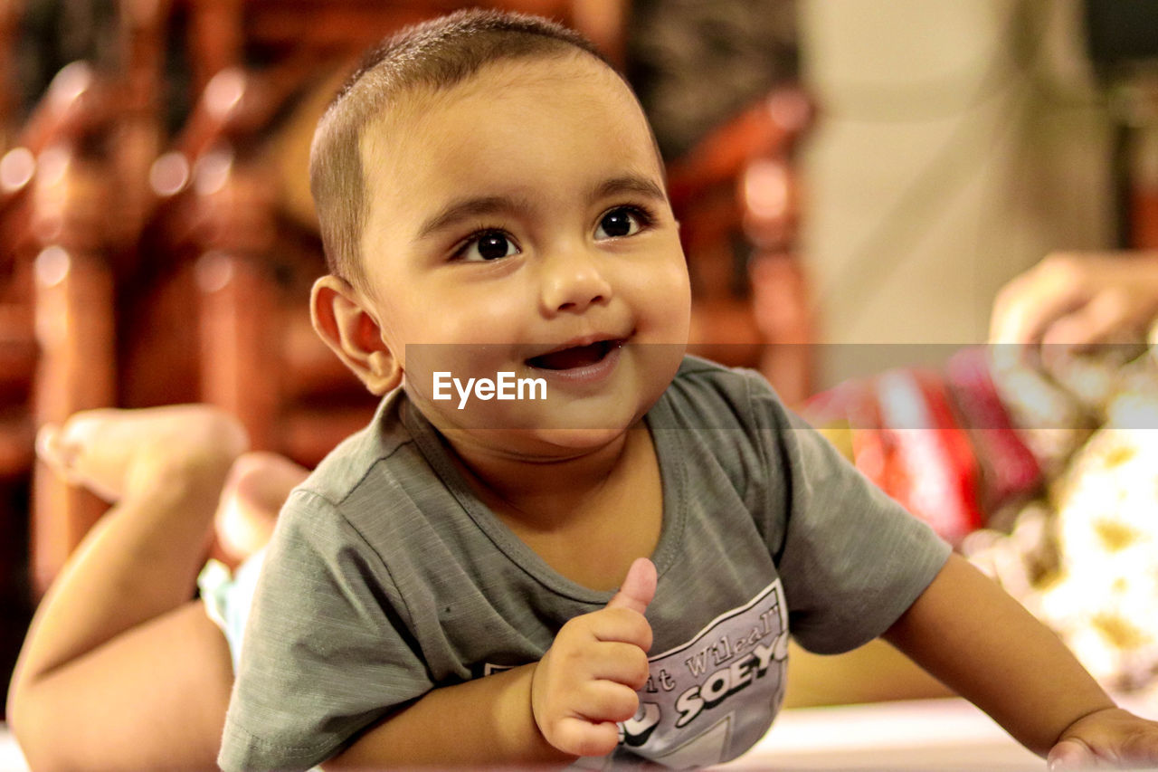 PORTRAIT OF CUTE BOY WITH BABY