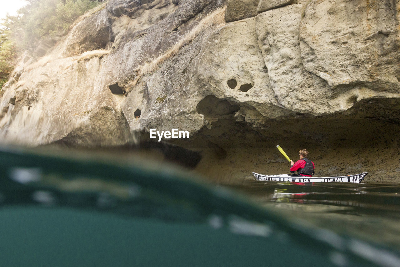 Water surface level of man kayaking over river