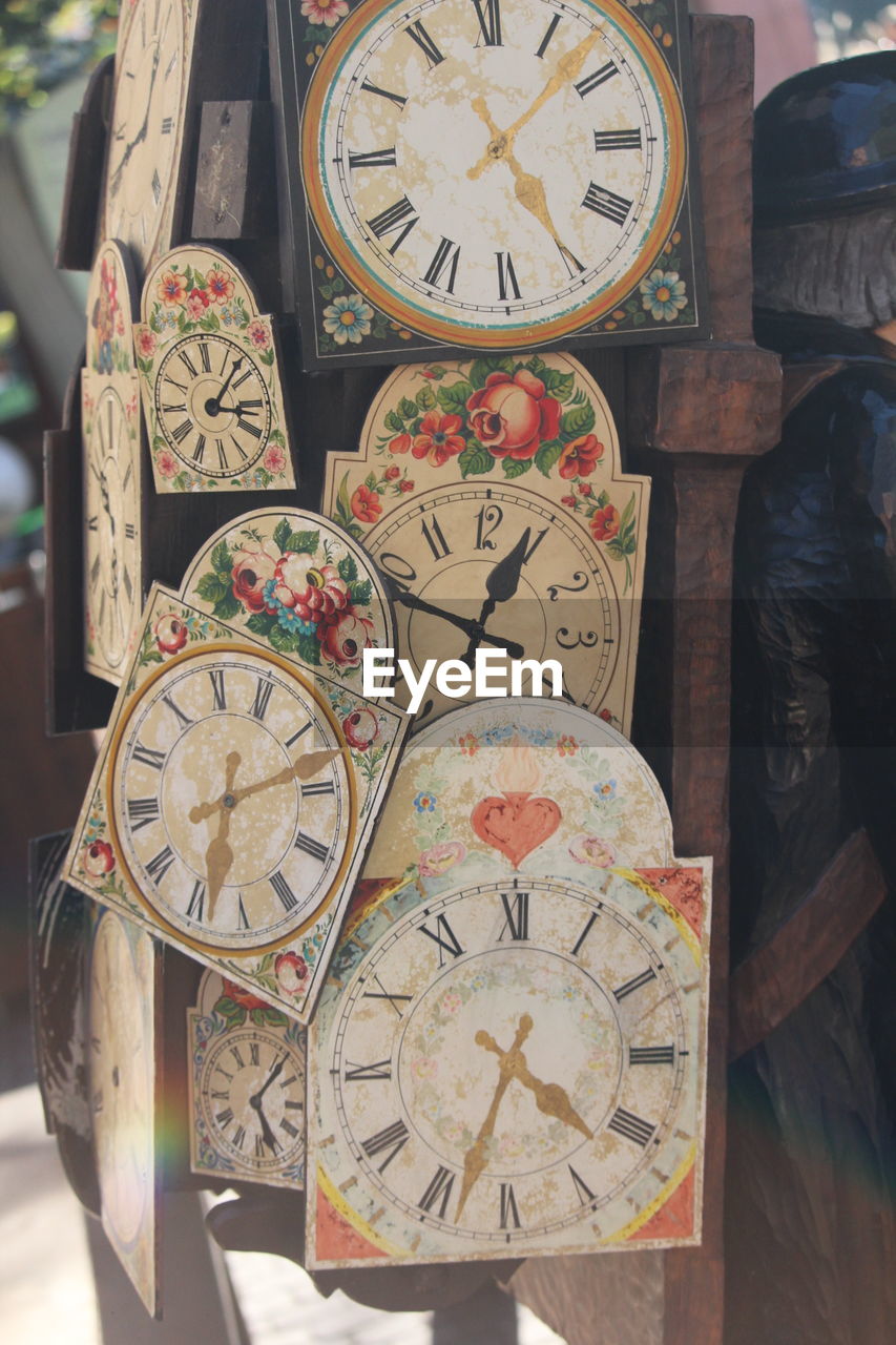 CLOSE-UP OF CLOCK HANGING ON WALL