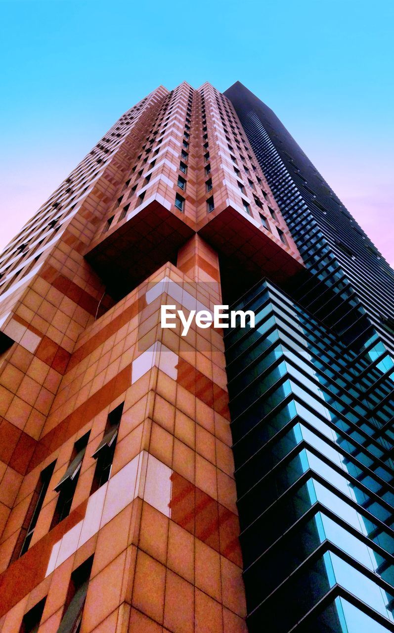 Low angle view of modern building against clear blue sky