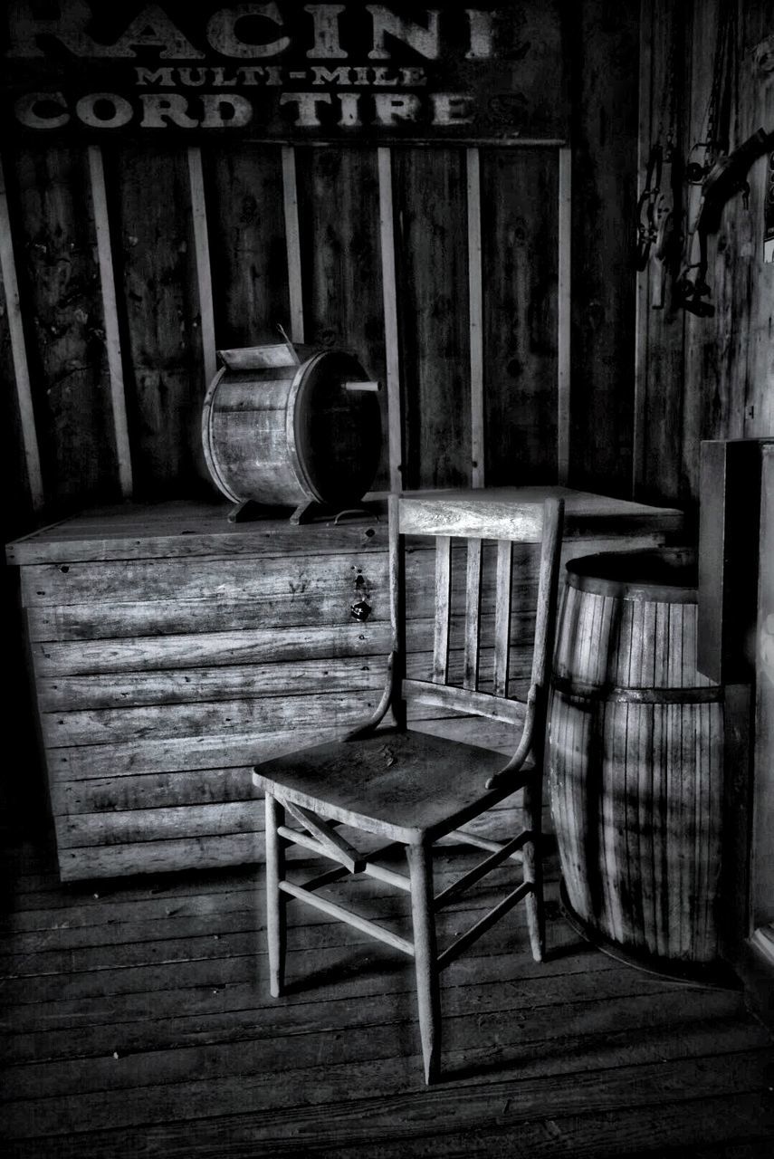 EMPTY CHAIRS AND TABLES IN FRONT OF WOODEN WINDOW