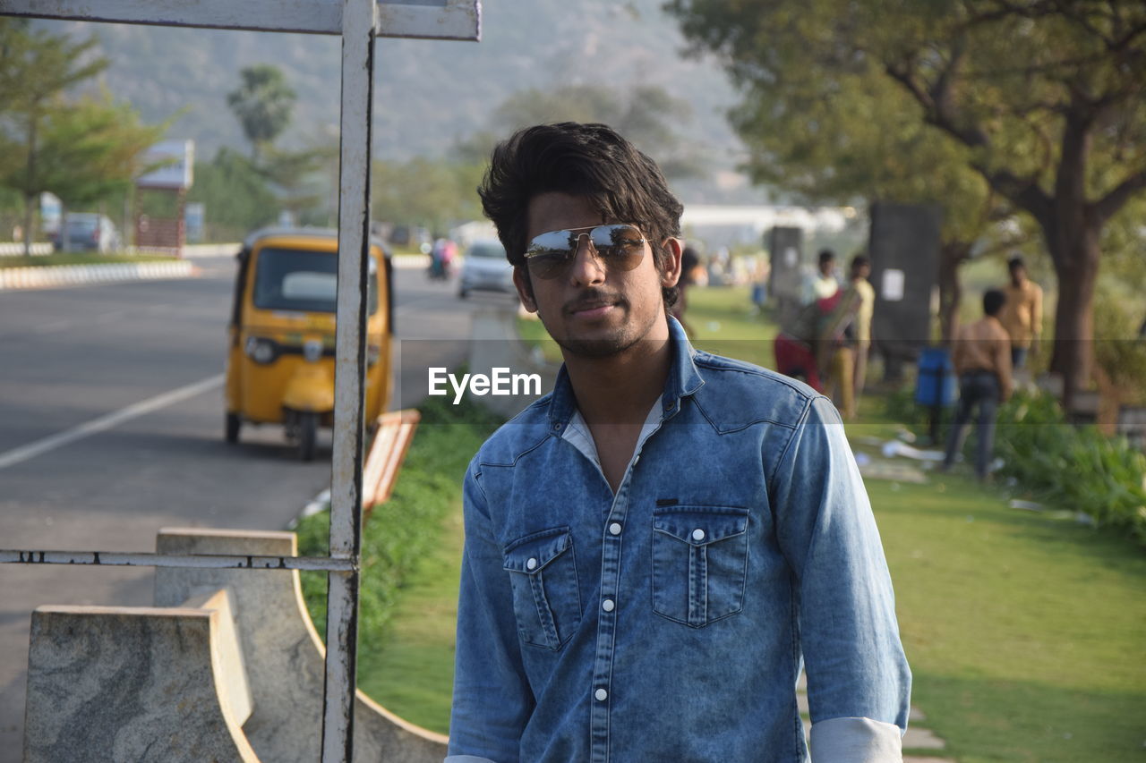 Portrait of young man standing on bus