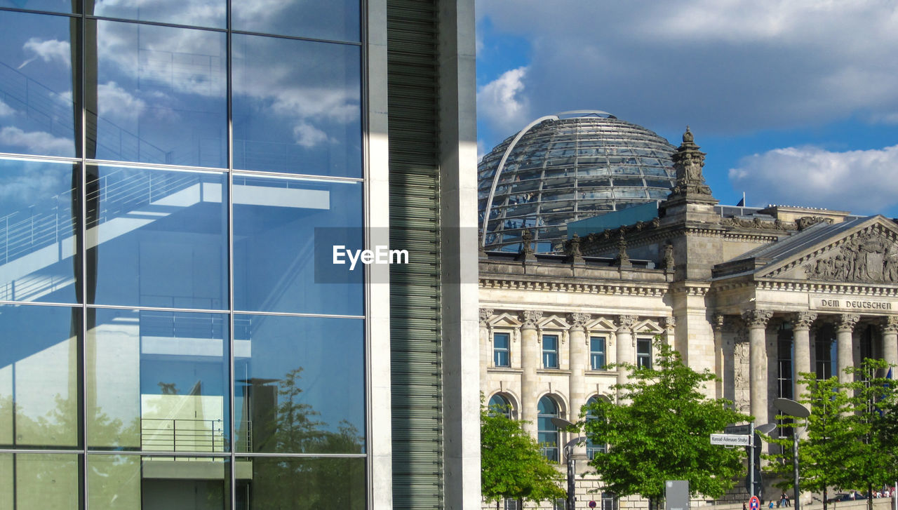 REFLECTION OF BUILDING IN GLASS WINDOW