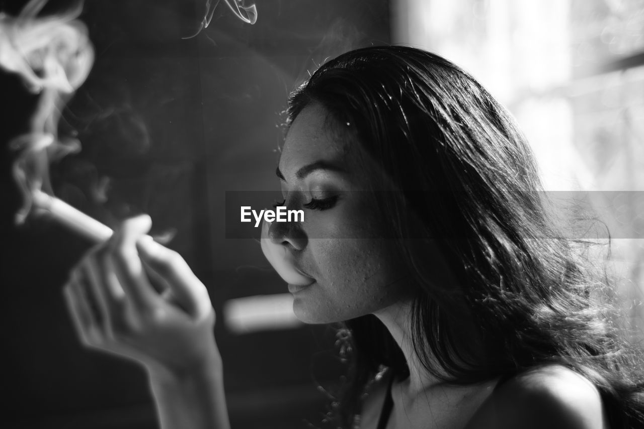 Close-up of young woman smoking
