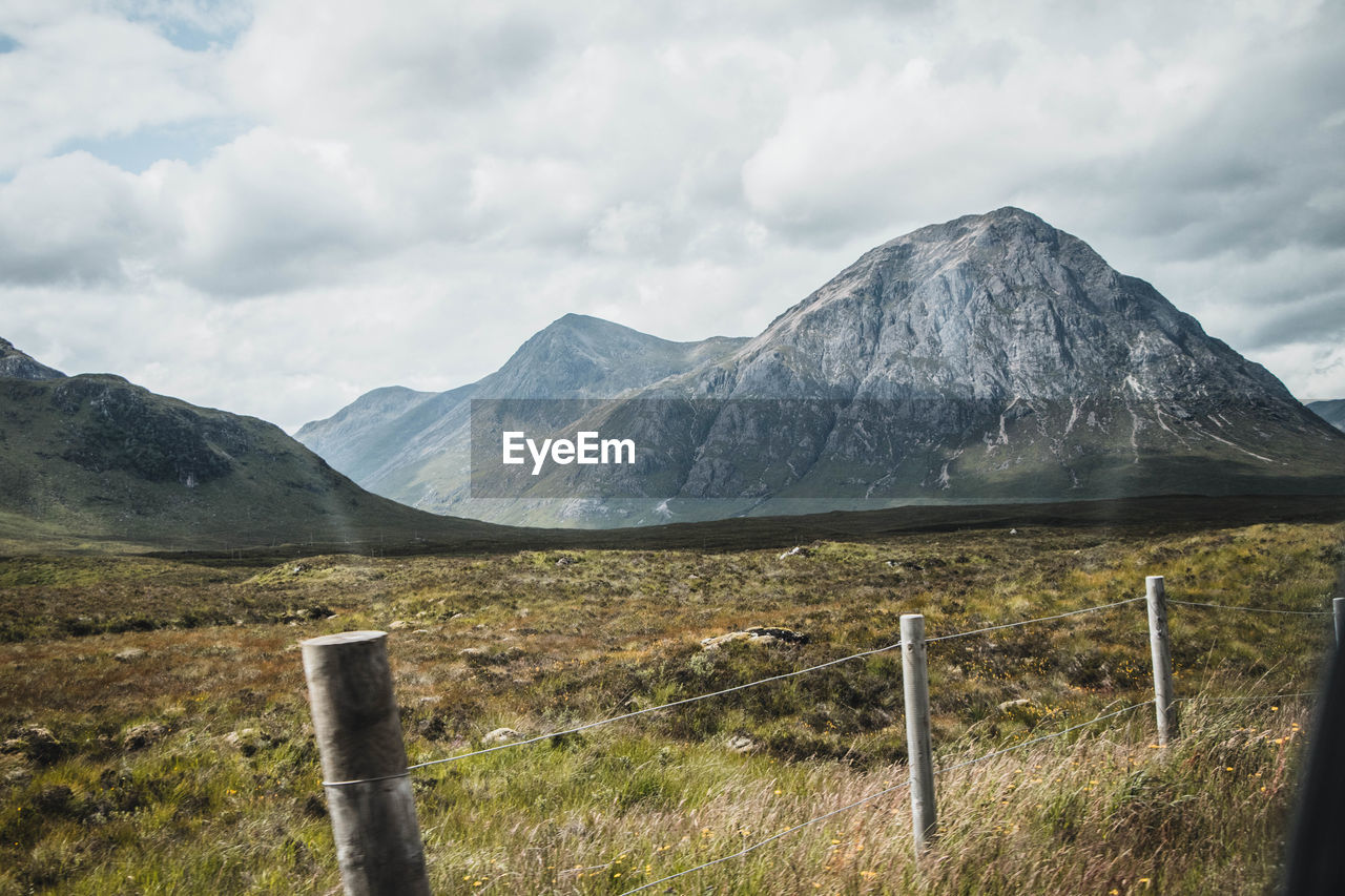 Scenic view of landscape against cloudy sky