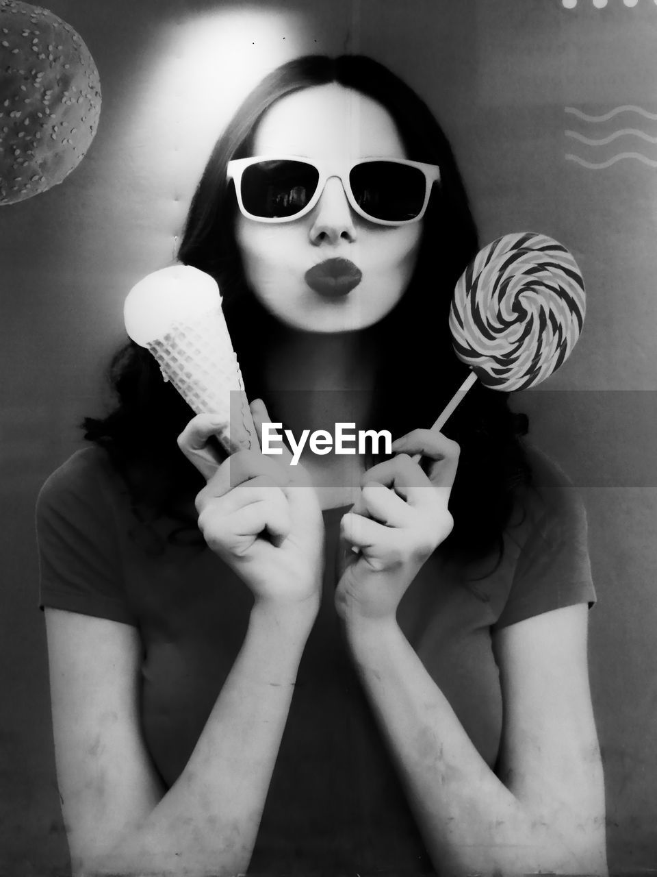 black and white, fashion, black, sunglasses, white, monochrome photography, one person, monochrome, glasses, adult, portrait, women, young adult, holding, indoors, eyewear, human face, person, looking at camera, vision care, front view, sweet food, female, sweet, cool, waist up, photo shoot, arts culture and entertainment, lifestyles, nose, studio shot