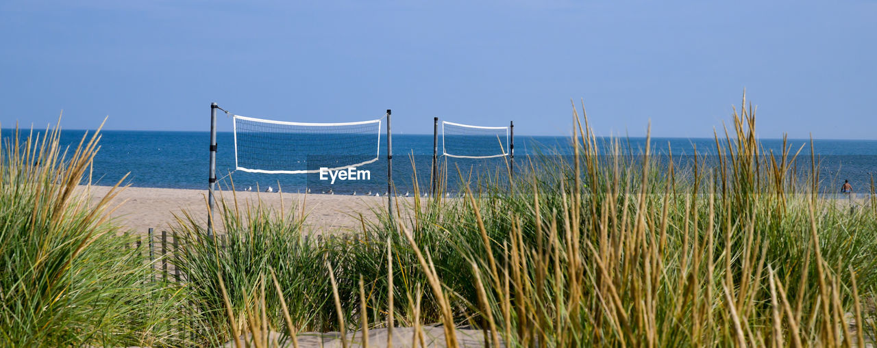 Empty beach volleyball nets on the lakeshore