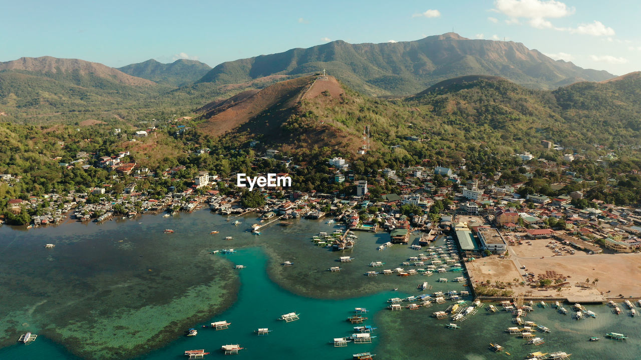 Coron city with slums and poor district. sea port, pier, cityscape coron town with boats on busuanga