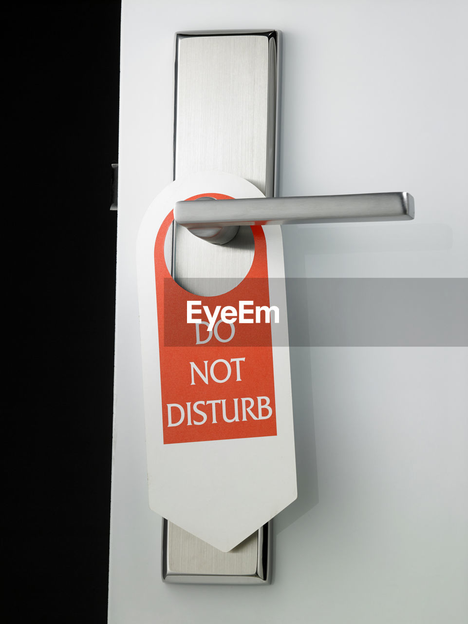 Close-up of do not disturb sign hanging on door handle