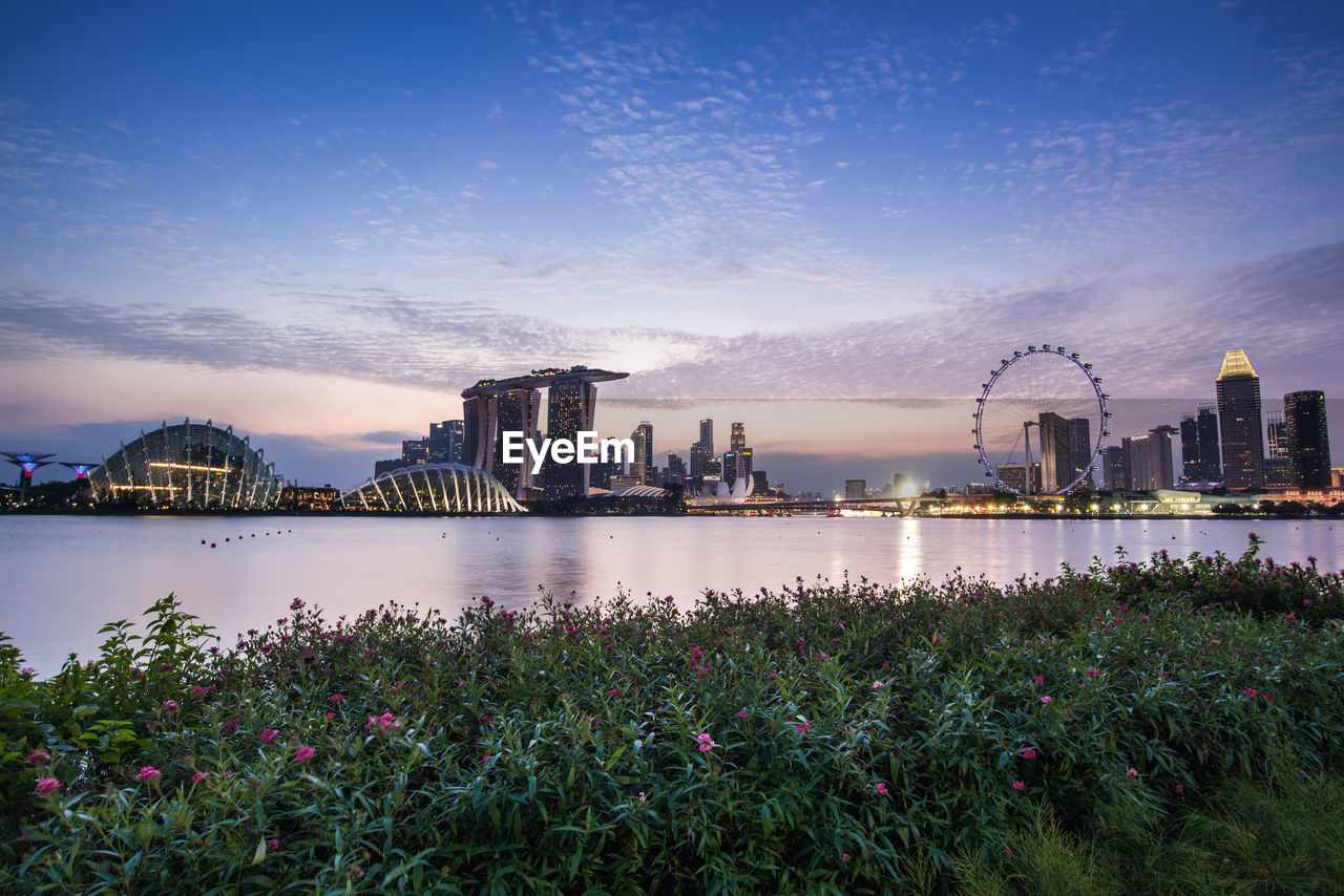 City at waterfront during sunset