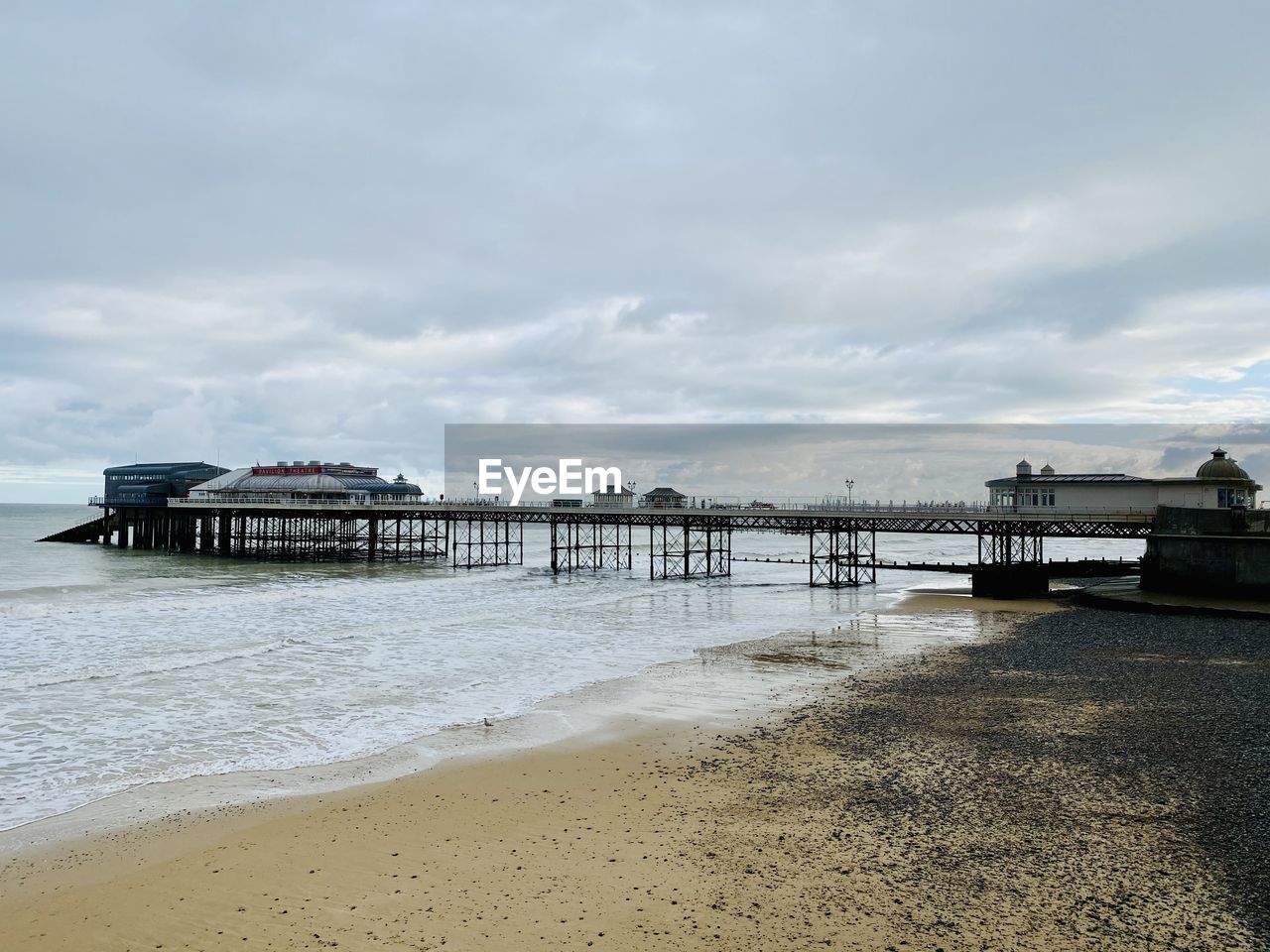 PIER AT BEACH AGAINST SKY